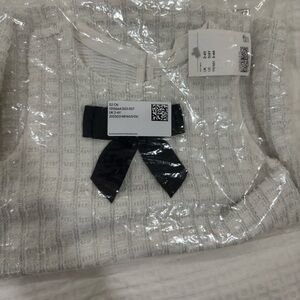 Elegant White Sleeveless Top with Black Bow